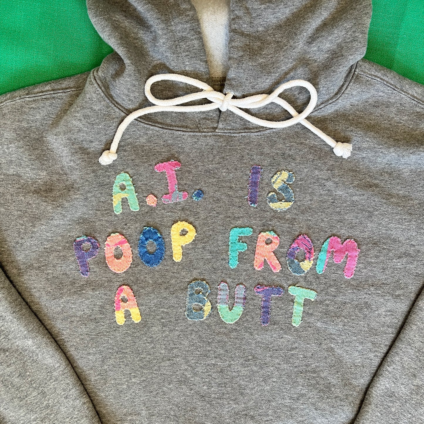 Grey cropped hoodie with multicolor letters