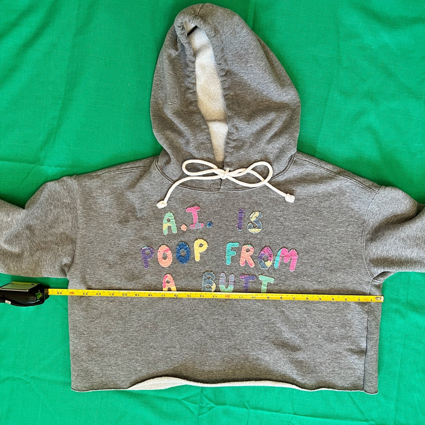 Grey cropped hoodie with multicolor letters