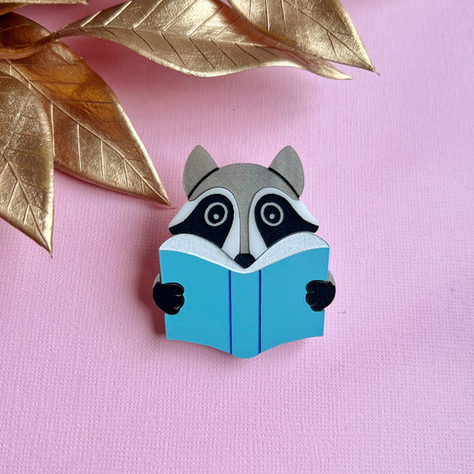 Reading raccoon brooch