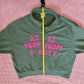 Army green pullover with bright pink letters